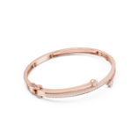Rose Gold Wavy Three-Stone Diamond Bangle with three bezel-set round diamonds